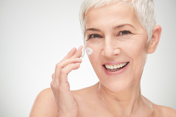Older Woman Putting on Face Cream