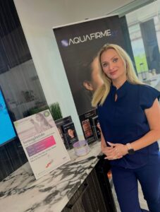 Cara Greer, CMLT, beside an AQUAfirme banner at Rejuvenate Renew med spa in Scottsdale, Arizona