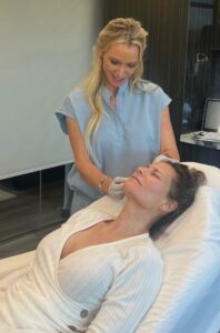 Cara Greer, CMLT, providing hands-on care to a client at Rejuvenate Renew med spa in Scottsdale, Arizona