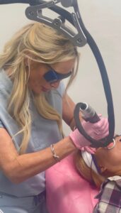 Cara Greer, CMLT, performing a laser skin treatment on a client at Rejuvenate Renew med spa in Scottsdale, Arizona